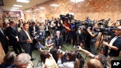 FILE - San Francisco Public Defender Jeff Adachi, left, talks to members of the media.