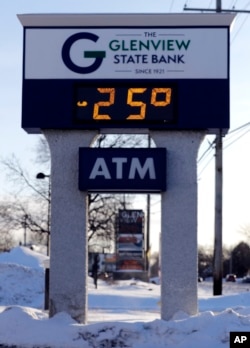 A sign shows the current outdoor temperature in Glenview, Ill., Jan. 30, 2019. A deadly arctic deep freeze enveloped the Midwest with some record-breaking temperatures on Wednesday.