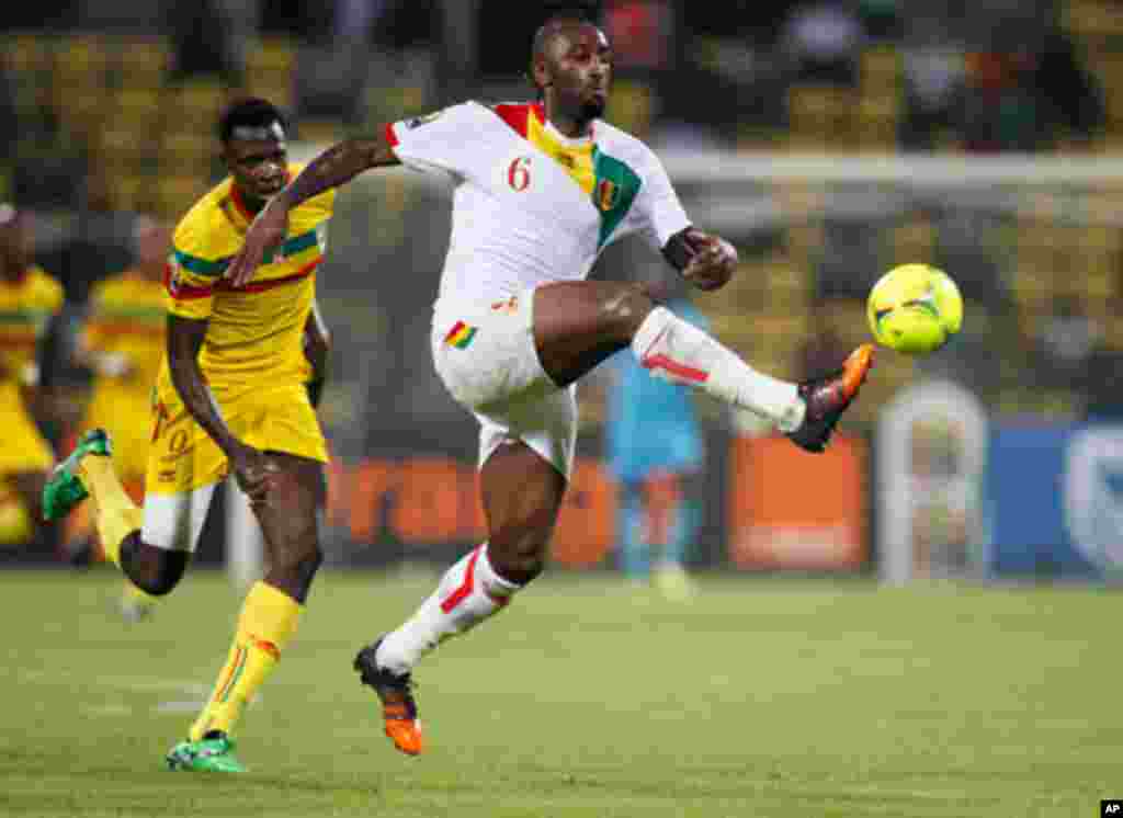Mali's Cheick Tidiane Diabate challenges Guinea's Kamil Zayatte for the ball during their African Nations Cup Group D soccer match at Franceville Stadium