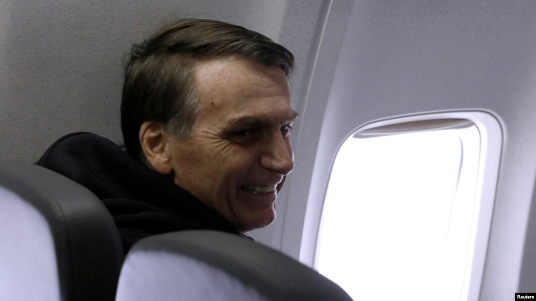 Brazilian presidential candidate Jair Bolsonaro sits on a plane in Sao Paulo, Sept. 29, 2018. 
