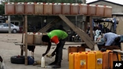 A man sells fuel on the road side in Kano, Nigeria, April 1, 2016. 