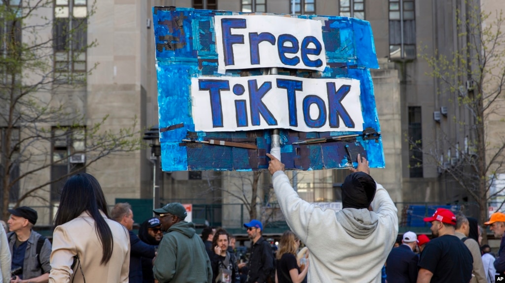 In this file photo, a man carries a Free TikTok sign in front of the courthouse where a trial of Donald Trump was underway on April 15, 2024, in New York. (AP Photo/Ted Shaffrey, File)