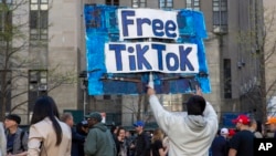 In this file photo, a man carries a Free TikTok sign in front of the courthouse where a trial of Donald Trump was underway on April 15, 2024, in New York. (AP Photo/Ted Shaffrey, File)