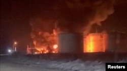 Fire and smoke rise at an oil depot following a Ukrainian drone attack, according to regional officials, in Novominskaya, Russia, in this screengrab obtained from a social media video released on Feb. 5, 2025. Social Media/via REUTERS