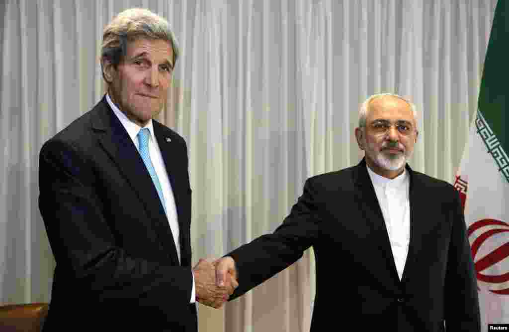 U.S. Secretary of State John Kerry shakes hands with Iranian Foreign Minister Mohammad Javad Zarif before a meeting in Geneva, Jan. 14, 2015.