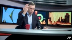 FILE - Russian opposition leader Alexei Navalny speaks at the Echo Moskvy (Echo of Moscow) radio station in Moscow, Russia, Dec. 27, 2017. 