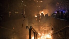 Protesters burn a subway station in Santiago, Chile, Monday, Oct. 28, 2019.