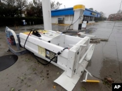 A gas pump lies on there ground after strong winds in Wilmington, N.C., toppled it after Hurricane Florence made landfall Friday, Sept. 14, 2018.