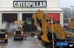 FILE - Heavy equipment is parked at the site of Caterpillar Belgium, in Gosselies, Belgium, Feb. 28, 2013.