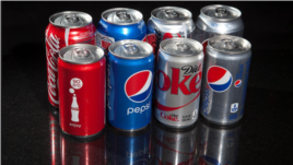 FILE PHOTO: Regular and mini cans of Coke and Pepsi are pictured in this photo illustration in New York, August 5, 2014. REUTERS/Carlo Allegro/File Photo
