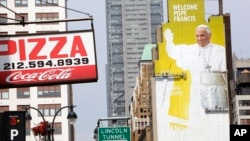 FILE - Sign painters work on a portrait of Pope Francis, right, on the side of a New York City building. The pope visits the U.S. beginning Sept. 22, with stops in Washington D.C., New York and Philadelphia. 