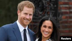 Britain's Prince Harry poses with Meghan Markle in the Sunken Garden of Kensington Palace, London, Britain, Nov. 27, 2017. 