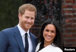 Britain's Prince Harry poses with Meghan Markle in the Sunken Garden of Kensington Palace, London, Britain, Nov. 27, 2017.