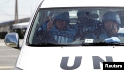 Filipino United Nations peacekeepers drive at the Kuneitra border crossing between Israel and Syria, in the Israeli occupied Golan Heights March 9, 2013. 