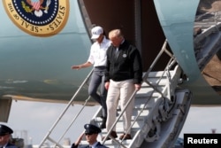U.S. President Donald Trump steps off Air Force One as the president arrives to tour storm damage from Hurricane Michael at Eglin Air Force Base, Florida, Oct. 15, 2018.