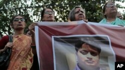 Bangladeshi social activists hold a banner displaying a portrait of blogger and author Ananta Bijoy Das during a protest against his killing, in Dhaka, Bangladesh, May 12, 2015.