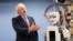 Britain's Foreign Secretary Boris Johnson gestures as he looks at a humanoid robot at Research Institute for Science and Engineering at Waseda University's campus in Tokyo.
