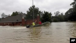 A rescue boat enters a flooded subdivision as floodwaters from Tropical Storm Harvey rise Aug. 28, 2017, in Spring, Texas.