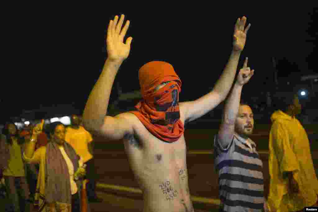 Demonstrators shout "Hands up, don't shoot," in Ferguson, Missouri, Aug. 20, 2014.