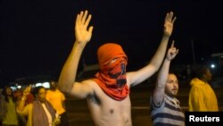 Demonstrators shout "Hands up, don't shoot," in Ferguson, Missouri, Aug. 20, 2014.