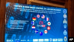 FILE - A screen shows part of Lockbit's dark-web leak site bearing the words "This site is now under control of law enforcement," during a press conference to explain an operation against the ransomware syndicate, in London, Feb. 20, 2024.