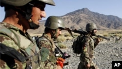 Afghan soldiers carry their weapons during a joint military patrol with US soldiers from Alpha Co, 2nd Battalion 35th Infantry, Task Force 'Cacti' in Walay valley, near the Afghanistan-Pakistan border in Kunar province, October 2, 2011.