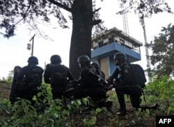 Anti-riot policemen take position as they arrive at the Pavon maximum security prison in Fraijanes municipality, Guatemala, May 7, 2019.