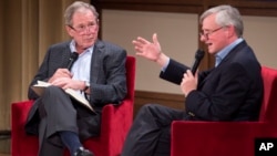 Former President George W. Bush, left, listens to Pulitzer Prize winning author Jon Meacham, right, talk about his biography of Bush's father, former President George H. W. Bush, Sunday, Nov. 8, 2015.