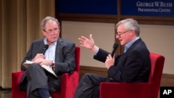Former President George W. Bush, left, listens to Pulitzer Prize winning author Jon Meacham, right, talk about his biography of Bush's father, former President George H. W. Bush, Sunday, Nov. 8, 2015.