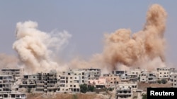 Smoke rises after airstrikes on a rebel-held part of the southern city of Daraa, Syria, June 15, 2017. 