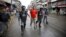 Nepalese police personnel detain a protester (C) during a general strike organized by the Nepal Federation of Indigenous Nationalities (NEFIN) demanding autonomous regions based on ethnicity to be drafted into the new constitution in Kathmandu, Nepal, Aug. 24, 2015.