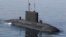 FILE - Iranian military personnel stand on a submarine during a naval parade on the last day of the Velayat-90 war game in the Sea of Oman near the Strait of Hormuz in southern Iran January 3, 2012.