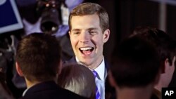 Conor Lamb, the Democratic candidate for the March 13 special election in Pennsylvania's 18th Congressional District, center, celebrates with his supporters at his election night party in Canonsburg, Pa., early March 14, 2018.