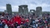 People celebrate the Winter Solstice sunrise celebrations at Stonehenge, England, Dec. 21, 2024. 