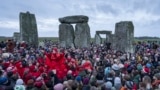 People celebrate the Winter Solstice sunrise celebrations at Stonehenge, England, Dec. 21, 2024. 