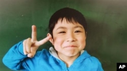 In this undated photo released Friday, 7-year-old Yamato Tanooka was shown at his elementary school. He was found safe Friday nearly a week after he was abandoned in the forest by his parents in northern Japan. (Hamawake Elementary School/Kyodo News via AP) 