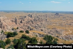 The landscape of the Badlands boasts a maze of buttes, canyons, pinnacles and spires, with sedimentary rock layers exposed by eons of erosion.