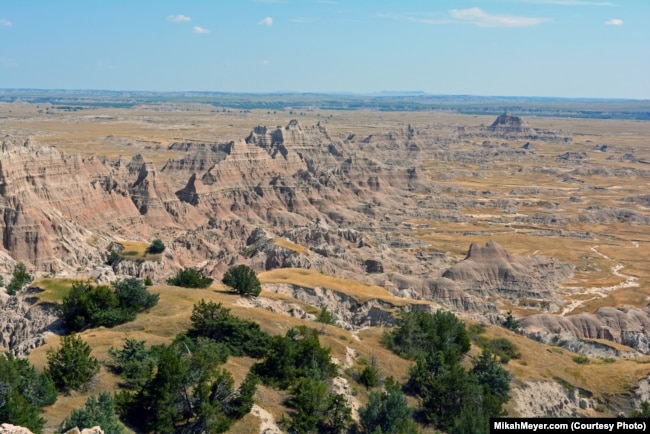 The landscape of the Badlands boasts a maze of buttes, canyons, pinnacles and spires, with sedimentary rock layers exposed by eons of erosion.