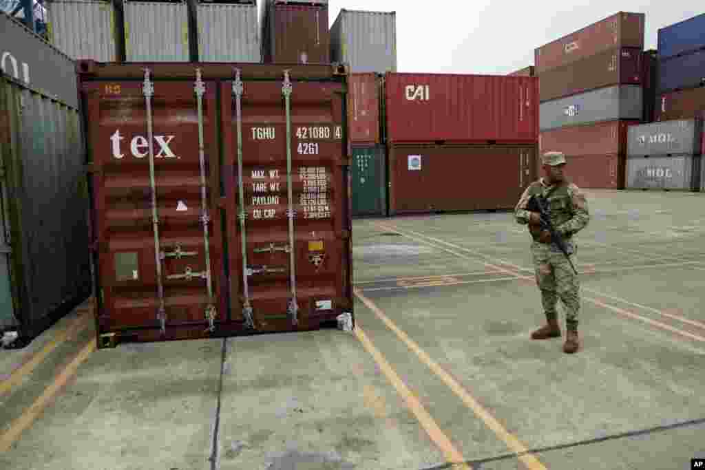 A police officer stands guard aboard the North Korean-flagged freighter, Chong Chon Gang, at the Manzanillo International container terminal on the coast of Colon City, Panama, July 17, 2013. 