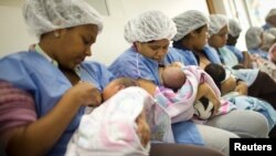 FILE - Mothers breastfeed their newborn babies in the natal intermediate care unit at the Santa Ana public maternity hospital in Caracas, Oct. 22, 2011. 