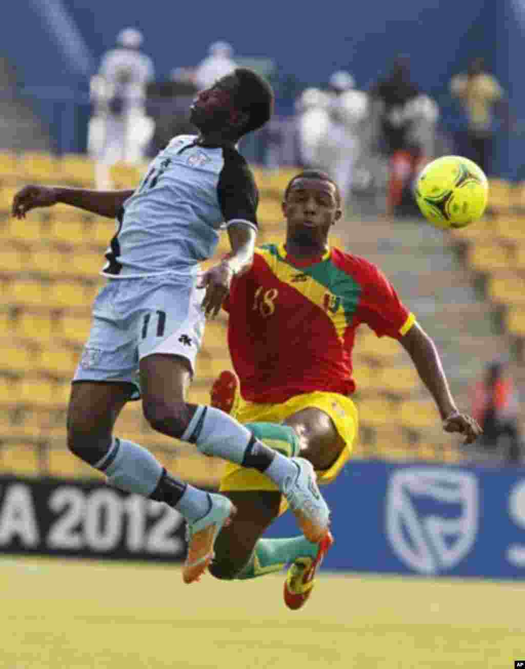 Guinea's Ibrahima Diallo (R) challenges Botswana's Dipsy Selolwane for the ball during their African Nations Cup Group D soccer match at Franceville Stadium January 28, 2012.