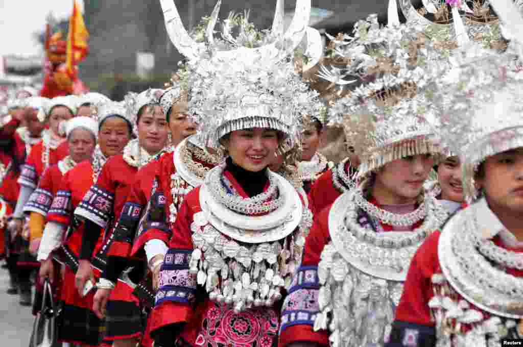 Ethnic Miao people wearing traditional costumes parade during Chinese Lunar New Year celebrations, in Taijiang county, Guizhou province, Feb. 11, 2016. 