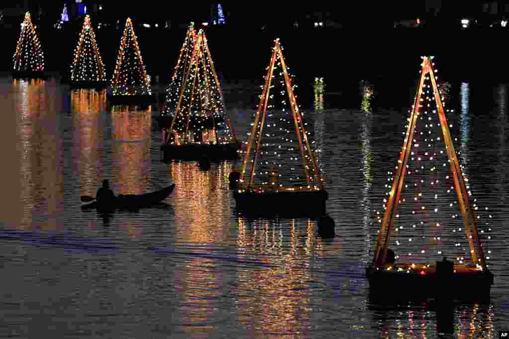 A kayaker is seen among holiday lights, December 16, 2020, in Long Beach, California.