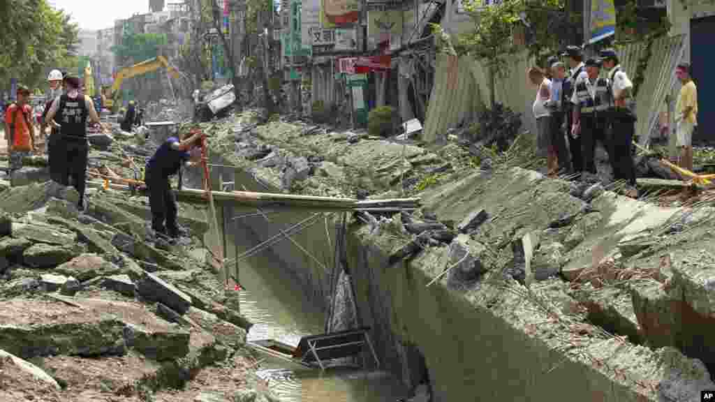 Rescue workers survey the damage from a massive gas explosion in Kaohsiung, Taiwan, Aug. 1, 2014. 