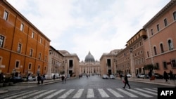 Tourists walk near St. Peter's square at the Vatican, March 3, 2020.