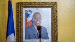 FILE - A picture of the late Haitian President Jovenel Moise hangs on a wall before a news conference by interim Prime Minister Claude Joseph, in Port-au-Prince, Haiti, July 13, 2021.