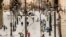 People walk through snow in downtown Madrid, Spain, Jan. 10, 2021 as a large part of central Spain including the capital Madrid are slowly clearing snow after the country's worst snowstorm in recent memory.