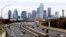 FILE - A view of Texas highway IH-30 traffic with the Dallas skyline. 