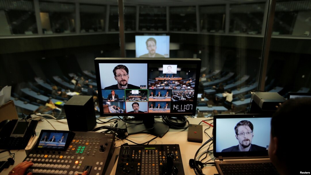 FILE - Edward Snowden speaks via video link as he takes part in a round table on the protection of whistleblowers at the Council of Europe in Strasbourg, France, March 15, 2019.