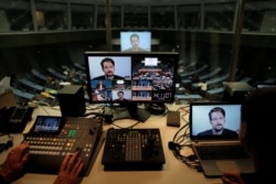 FILE - Edward Snowden speaks via video link as he takes part in a round table on the protection of whistleblowers at the Council of Europe in Strasbourg, France, March 15, 2019.